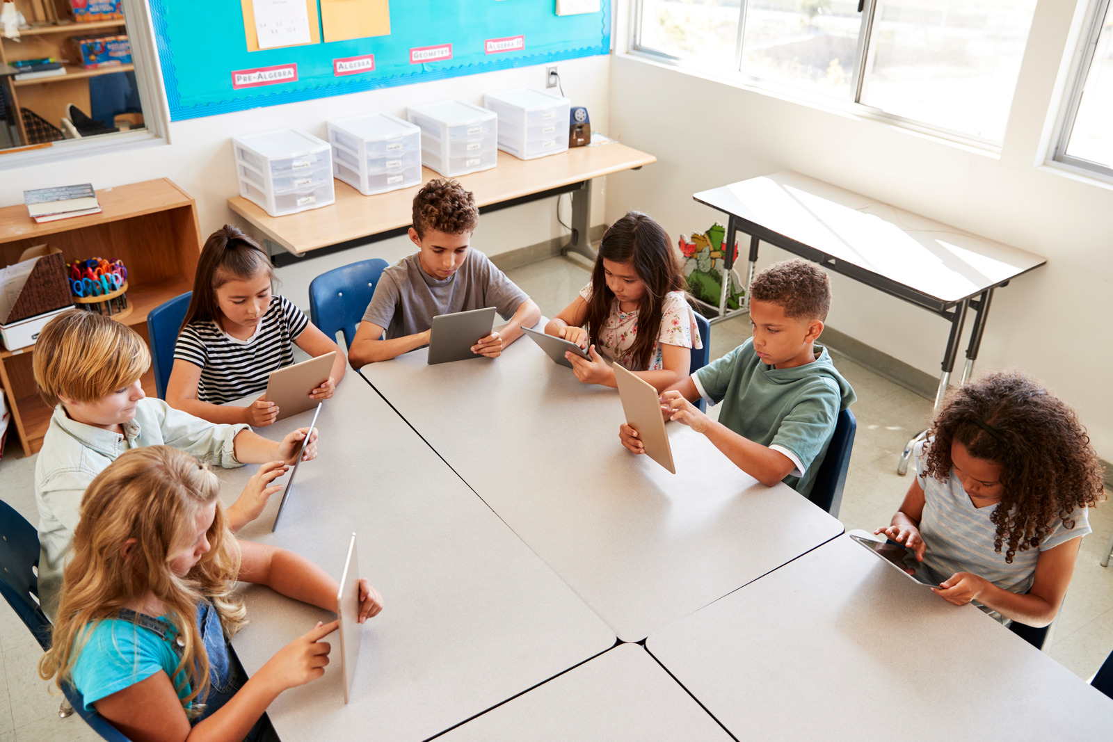 Young kids using tablets in school lesson, elevated view - KidsProef